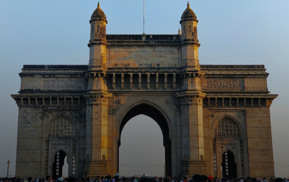 The image shows the Gateway of India, a historic arch monument located in Mumbai.